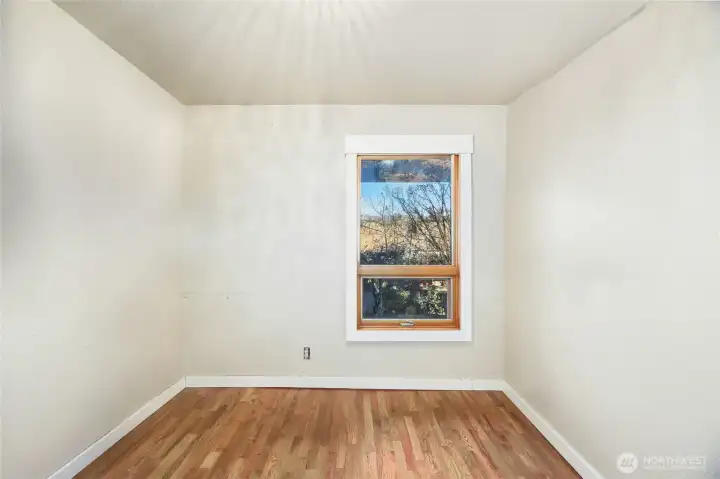 Bedroom #2  Barn door entry / Closet  Views of side garden patio  Beautiful hardwood floors