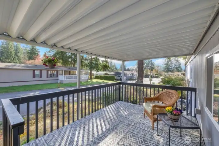 This large covered porch is such a cheerful place to enjoy the out-of-doors.