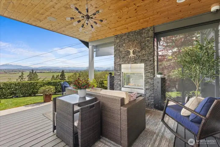 Out the slider doors to this covered deck- perfect for year round relaxation and entertaining. Built in fireplace, Built in BBQ, Overhead hard wired speakers keep the vibe going.