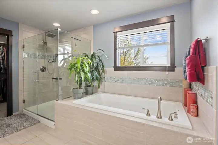 Frameless glass walk in shower and large soaking tub