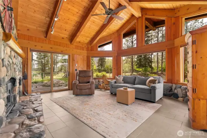 The living room showcases a stunning river rock hearth and chimney with matching stonework wrapping the lower walls. Walk out into your back yard from the living room through sliding doors. The living room showcases a stunning river rock hearth and chimney with matching stonework wrapping the lower walls. Walk out into your back yard from the living room through sliding doors.