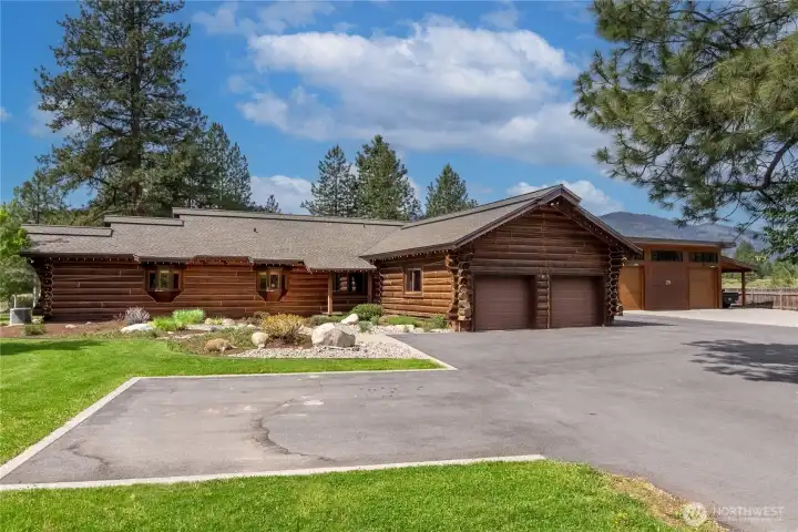Stone, log, and cedar exterior with a two-car air conditioned and heated attached garage. Stone, log, and cedar exterior with a two-car air conditioned and heated attached garage.