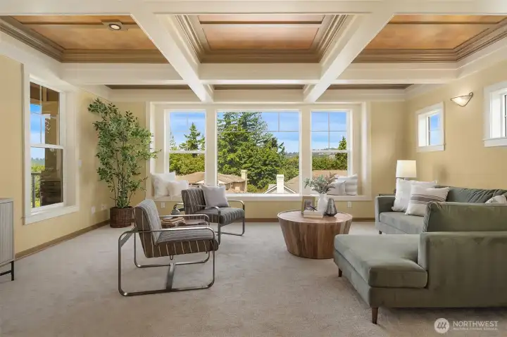 Anchored by a dramatic coffered ceiling and walls of windows, the family room is filled with natural light and captures peaceful glimpses of Lake Washington, the Bellevue skyline, surrounding mountains, and territorial vistas. Anchored by a dramatic coffered ceiling and walls of windows, the family room is filled with natural light and captures peaceful glimpses of Lake Washington, the Bellevue skyline, surrounding mountains, and territorial vistas.