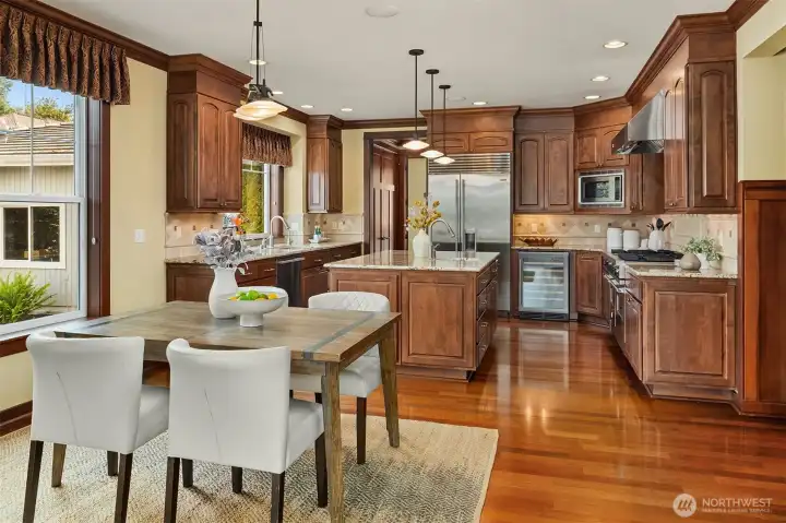 A generous kitchen and casual dining area create an easy everyday hub, with ample workspace, abundant storage, and a natural connection to the family room beyond. A generous kitchen and casual dining area create an easy everyday hub, with ample workspace, abundant storage, and a natural connection to the family room beyond.