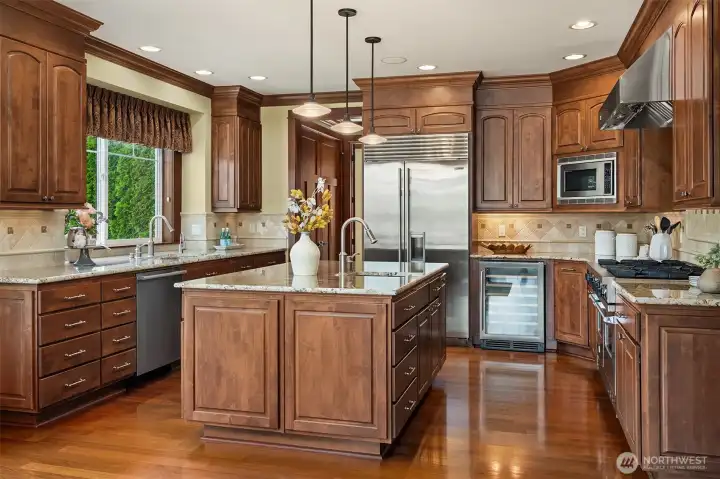 Equipped for everything from weeknight meals to holiday entertaining, the chef's kitchen features a professional-style range, oversized island, abundant prep space, and extensive custom cabinetry. Equipped for everything from weeknight meals to holiday entertaining, the chef's kitchen features a professional-style range, oversized island, abundant prep space, and extensive custom cabinetry.