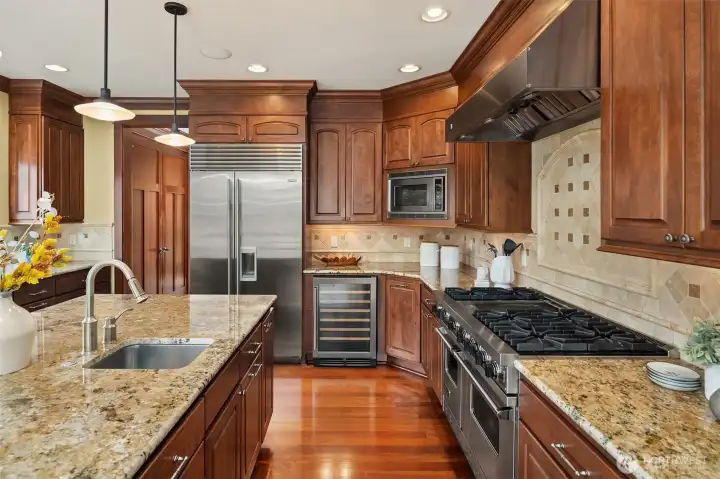 Designed for serious cooking and effortless hosting, the kitchen features professional-style appliances, expansive counters, a wine fridge, a large center island, and thoughtful storage throughout. Designed for serious cooking and effortless hosting, the kitchen features professional-style appliances, expansive counters, a wine fridge, a large center island, and thoughtful storage throughout.