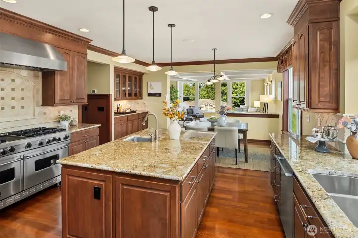 The heart of the home, where the chef's kitchen and sunlit breakfast area create an inviting space for everything from quiet mornings to lively gatherings. The heart of the home, where the chef's kitchen and sunlit breakfast area create an inviting space for everything from quiet mornings to lively gatherings.