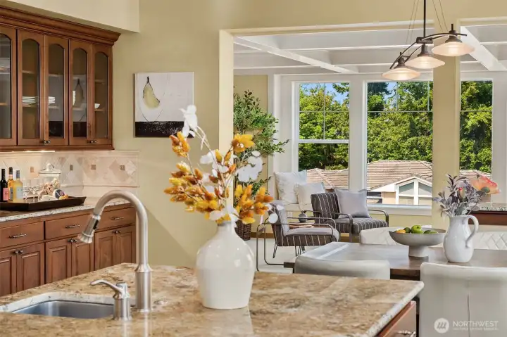Whether preparing dinner or entertaining guests, the chef's kitchen remains connected to the family room, where oversized windows frame peek-a-boo views and bring the outdoors in. Whether preparing dinner or entertaining guests, the chef's kitchen remains connected to the family room, where oversized windows frame peek-a-boo views and bring the outdoors in.