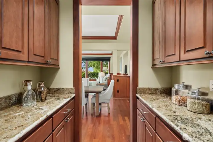 An expansive walk-in pantry offers exceptional storage and organization, keeping the kitchen beautifully equipped yet effortlessly uncluttered. An expansive walk-in pantry offers exceptional storage and organization, keeping the kitchen beautifully equipped yet effortlessly uncluttered.