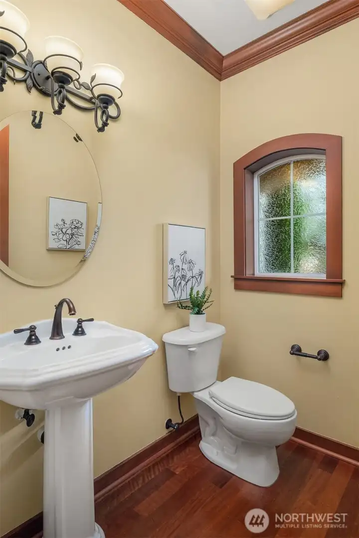 Conveniently located on the main level, the powder room pairs timeless finishes with classic design. Conveniently located on the main level, the powder room pairs timeless finishes with classic design.