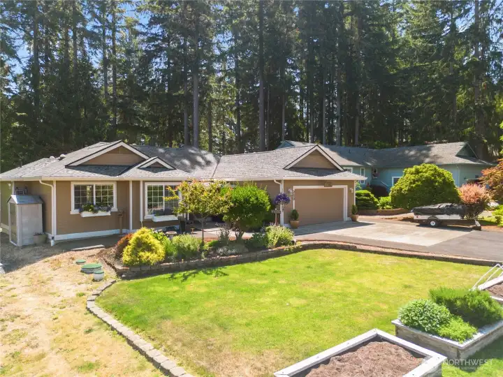 Welcome home with garden beds and mature plants. sidewalk leading to the home and paved driveway. Welcome home with garden beds and mature plants. sidewalk leading to the home and paved driveway.
