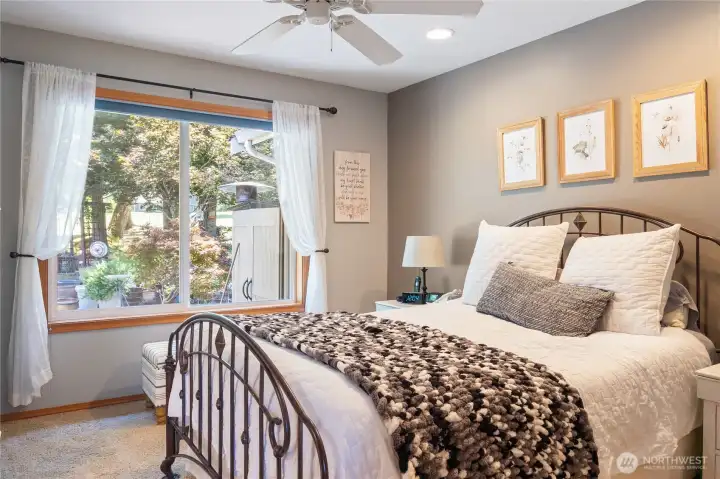 Primary bedroom with ceiling fan looks to the golf course and backyard. Primary bedroom with ceiling fan looks to the golf course and backyard.