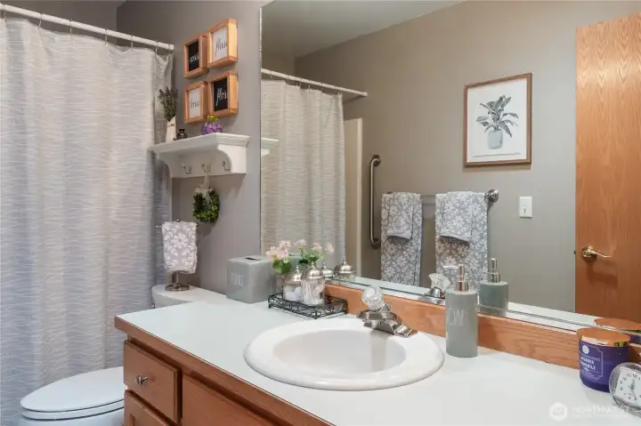 Guest bath with full tub and shower combo. Guest bath with full tub and shower combo.