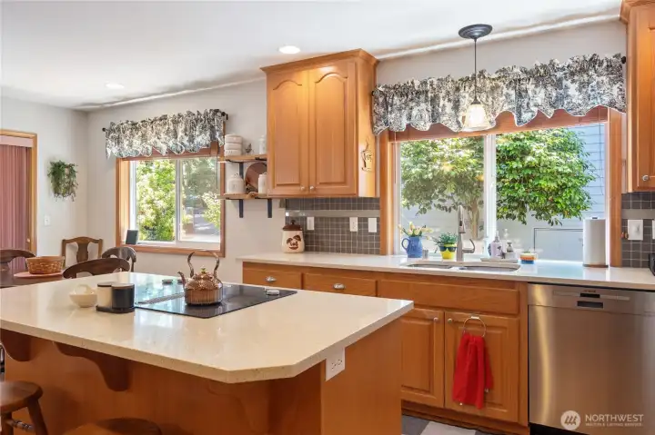 Kitchen with updated appliances and clean cupboards. White oak flooring. Kitchen with updated appliances and clean cupboards. White oak flooring.