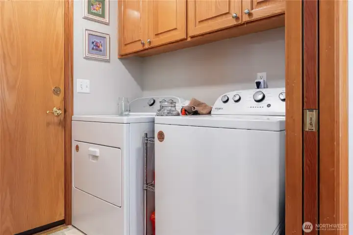Laundry room with storage and a pocket door. Laundry room with storage and a pocket door.