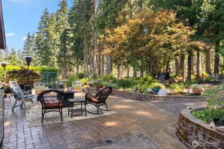 Patio out back with raised beds and path to the course. Patio out back with raised beds and path to the course.