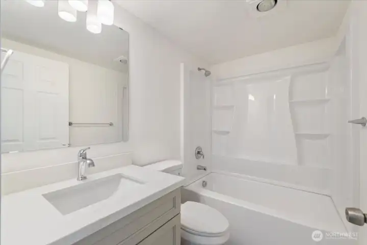 Hall/guest bath is all brand new! Equipped with custom tub surround, undermount sink, quartz counters and solid wood cabinetry. Hall/guest bath is all brand new! Equipped with custom tub surround, undermount sink, quartz counters and solid wood cabinetry.