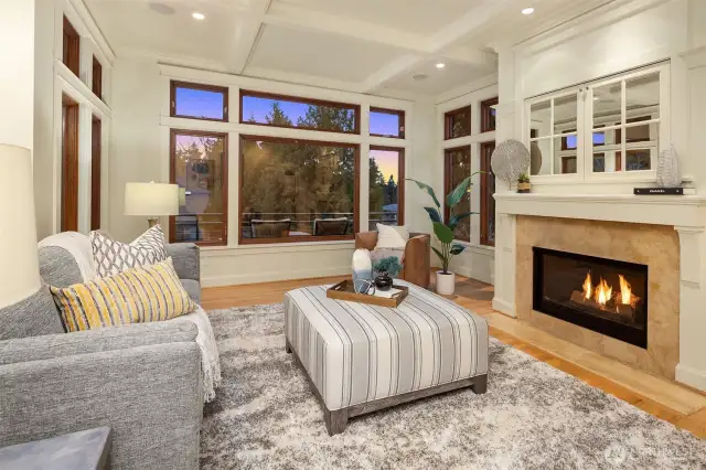 Box beam ceilings, a substantial fireplace and elevated ceilings make this family room a favorite place to gather.