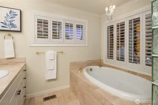 Settle into a soothing bath and say goodbye to the stresses of the day! Beautiful plantation shutters adorn the primary bath and the entire suite.