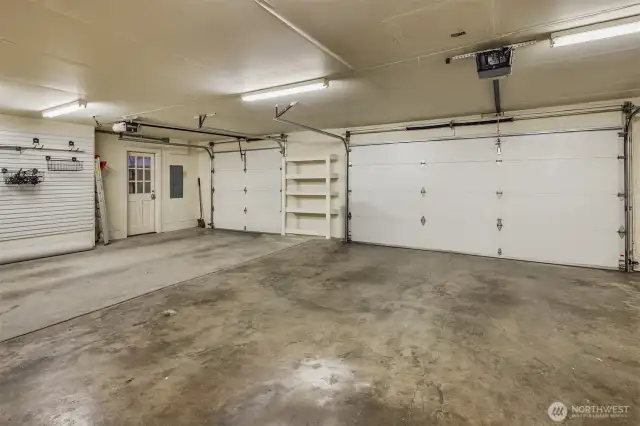 Clean as a whistle. Big, bright garage boasts space for 3 cars, a work bench and its own side entrance area.