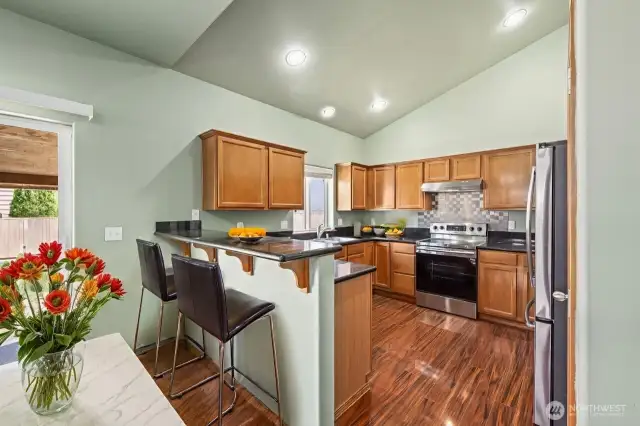 Kitchen open to Family Room w/ Vaulted Ceilings