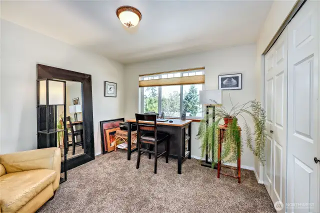This room is used as an office. It is on the same floor as the primary suite and living room area.