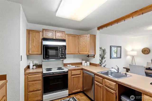 The kitchen opens up to the dining area, lots of light, counter space and extra space for more than one cook!