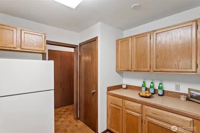 A buffet style counter in the kitchen with a kitchen pantry to add even more storage.
