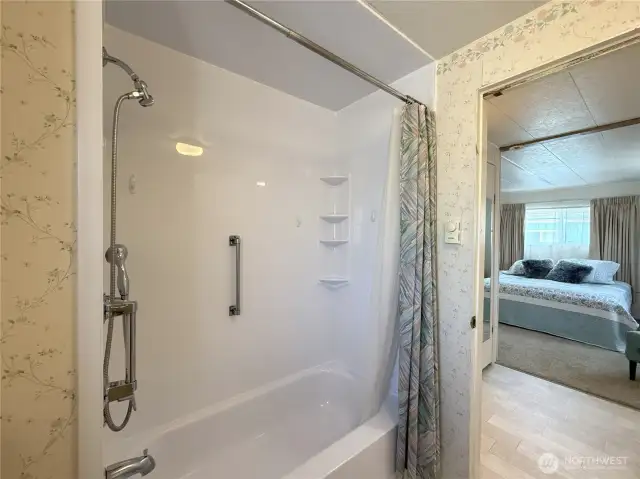 Looking from primary bathroom to bedroom