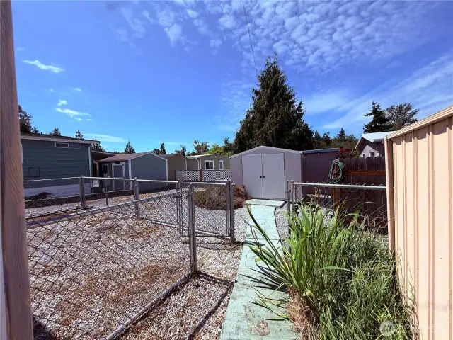 Nice size lot featuring 2 storage sheds and fenced area with plenty of room to add gardens, BBQ areas, and outside living space