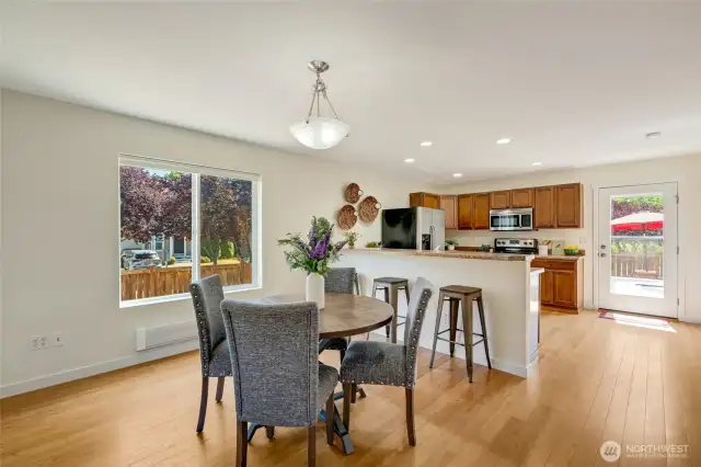 Dining area, counter height bar, kitchen with access to rear fenced yard.