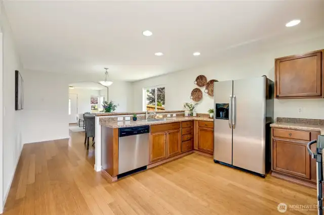 Kitchen looking toward the front of the house. Space for a hutch in the dining space. Line up the barstools for casual eating.
