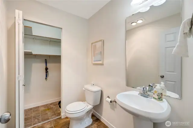 Half bath with storage on the main level.