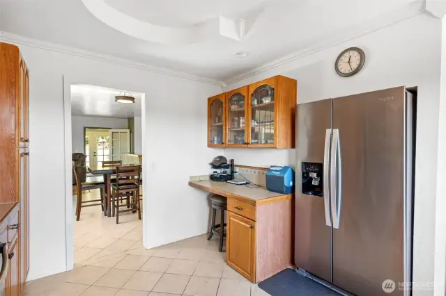 Kitchen with desk/work station or coffee bar.