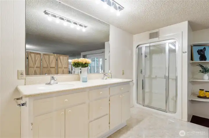 Primary bath with double sinks and walk in shower.