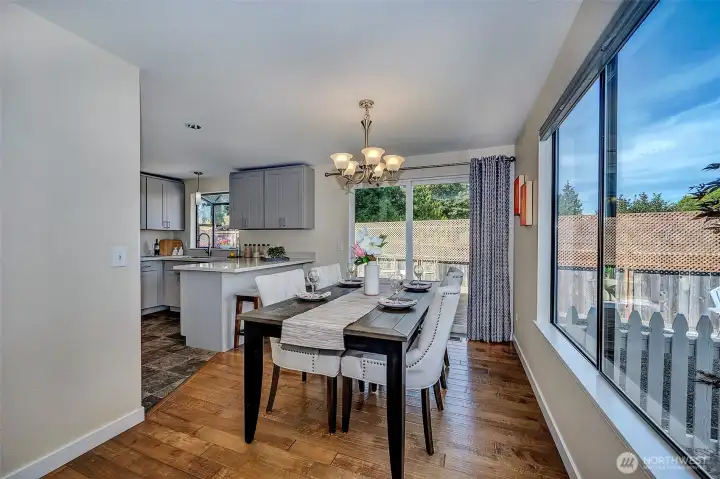 The sliding glass door leads to a raised deck, fire pit and hot tub.