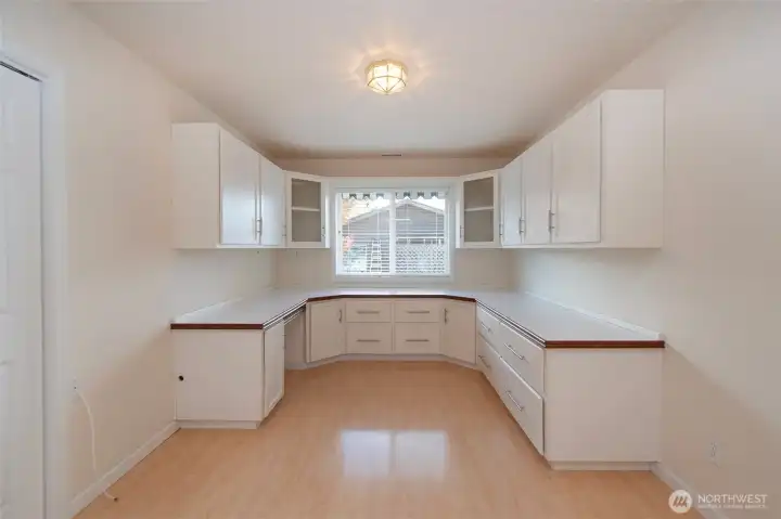 Office with custom cabinets and drawers.