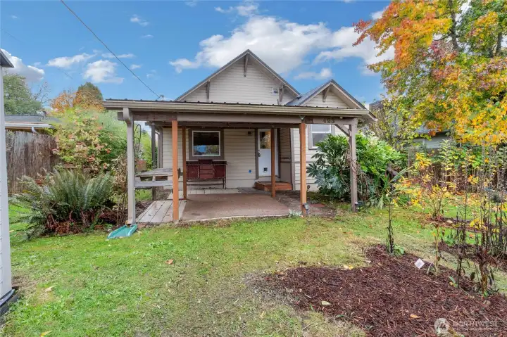 Backyard has large covered space, tons of fruit trees and lounging space!