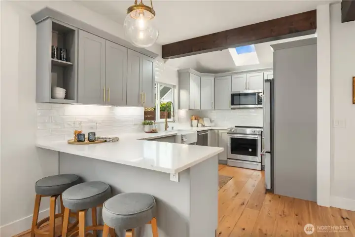 This wonderfully laid out kitchen features lots of counter space and cabinetry and a tiled backsplash.