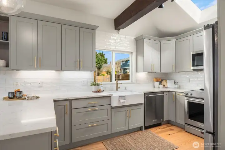 The vaulted ceiling over the kitchen has a large skylight that pours in even more natural light.