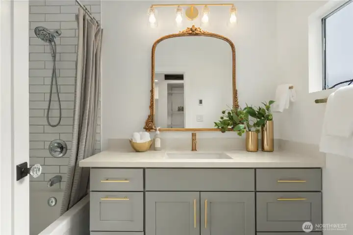 This lovely bath features heated tile floors and a tiled bath surround as well as great storage in the oversized vanity.