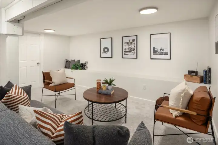 This spacious rec room is extremely versatile and very large. Just through the closed door is the large laundry area.