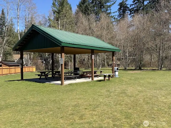 The bigger community park is one street over with a covered picnic table, large swimming lake, and playground equipment