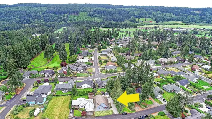 Aerial view facing East shows the home in proximity to the neighborhood and golf course.  Unlimited golf for your immediate family is included in your HOA dues!