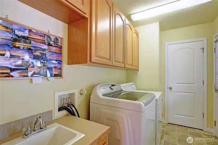 The laundry room with a utility sink is just off the kitchen, leading to the wrap around front porch.