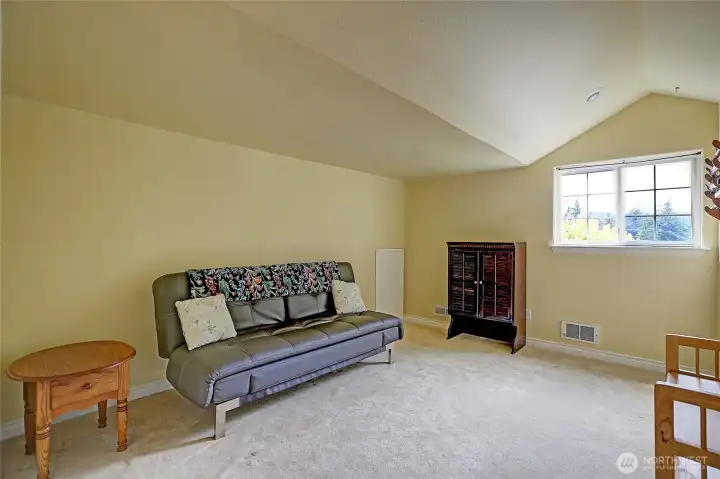 The upstairs loft is very spacious and can serve as a bedroom or additional living area with a full bathroom.