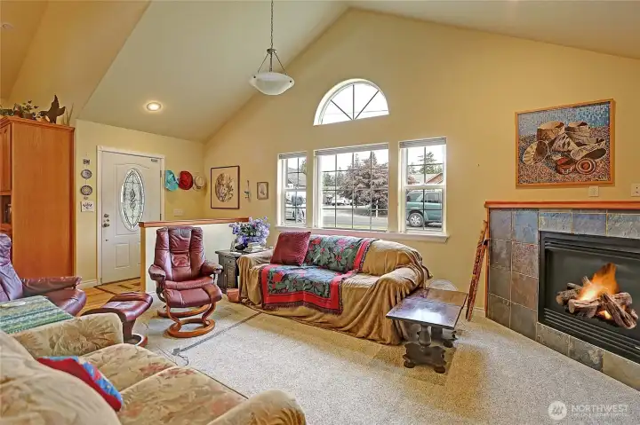 This thoughtfully designed custom home features tall vaulted ceilings in the living room.