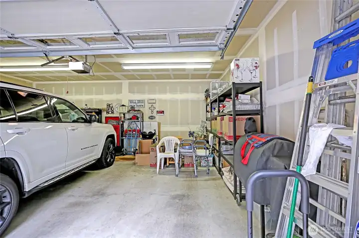 Plenty of space for parking or storing your golf cart in this attached two car garage.