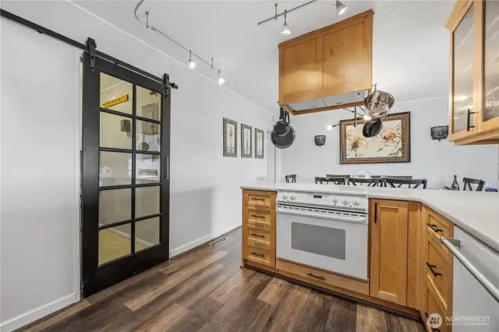 The barn door leads from the kitchen to the laundry and pantry room. The barn door leads from the kitchen to the laundry and pantry room.