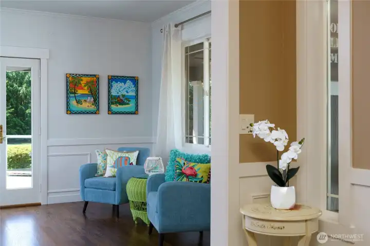 Entry way looking into Formal Living room with patio doors to large side deck. Additional hardwood floors added to formal living, formal dining and office in 2018. Entry way looking into Formal Living room with patio doors to large side deck. Additional hardwood floors added to formal living, formal dining and office in 2018.